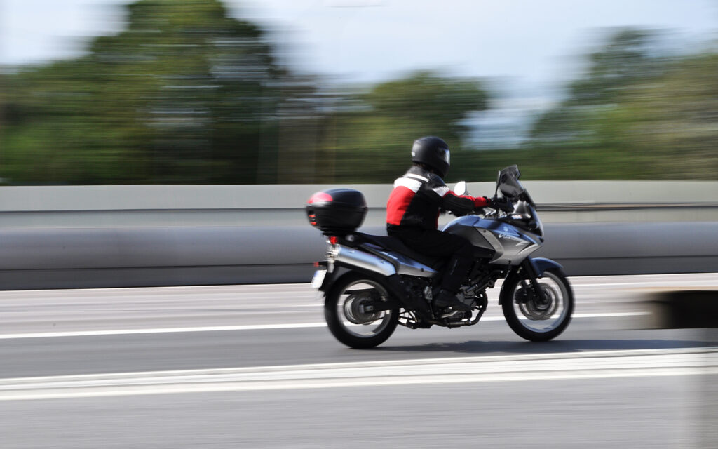 Motorcyclist driving down the Savannah, Georgia highway on a sunny day.