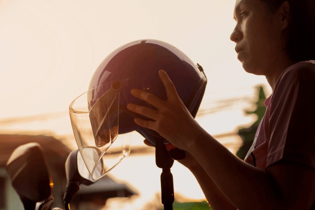 motorcycle rider putting helmet on